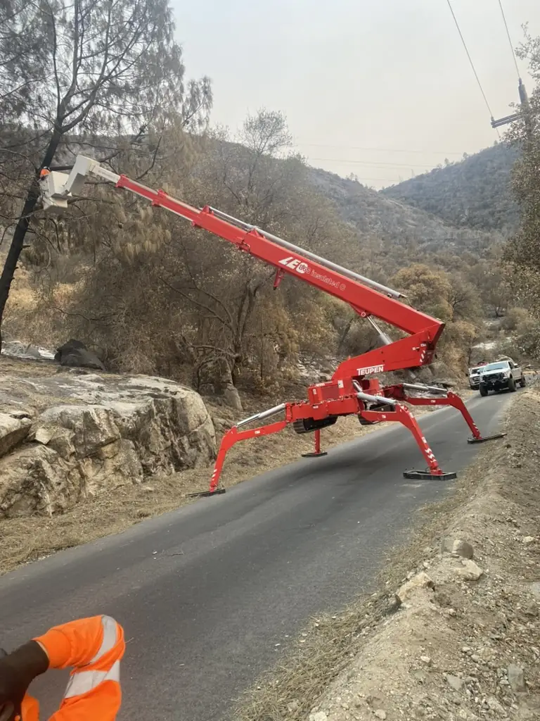Red tracked lift deployed for roadside tree work