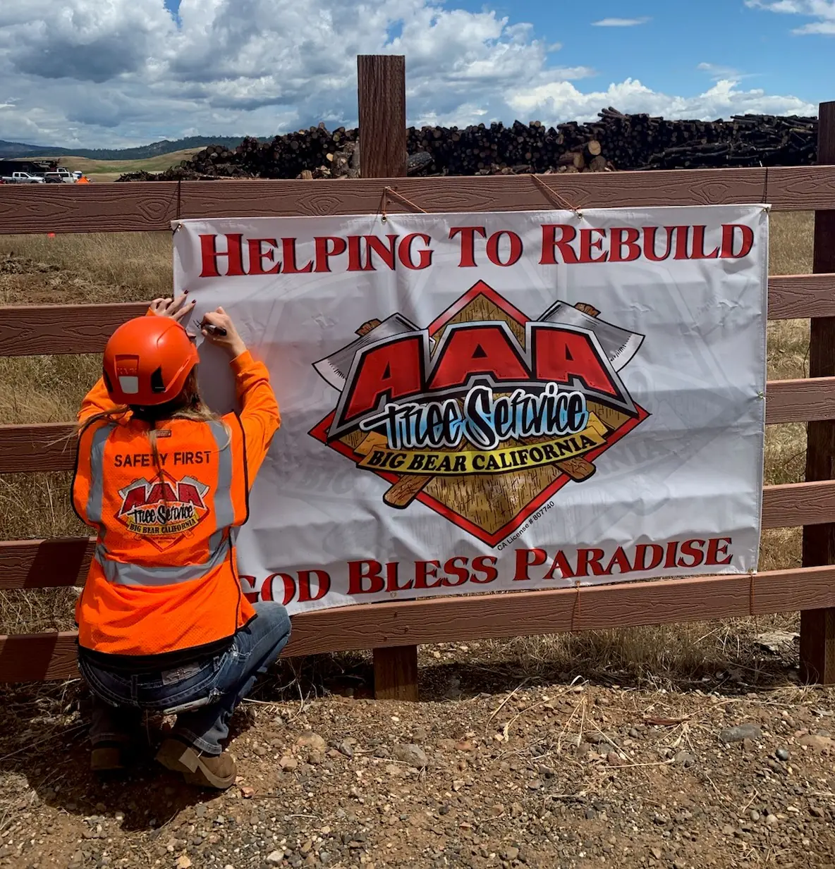 AAA crew member beside the company banner